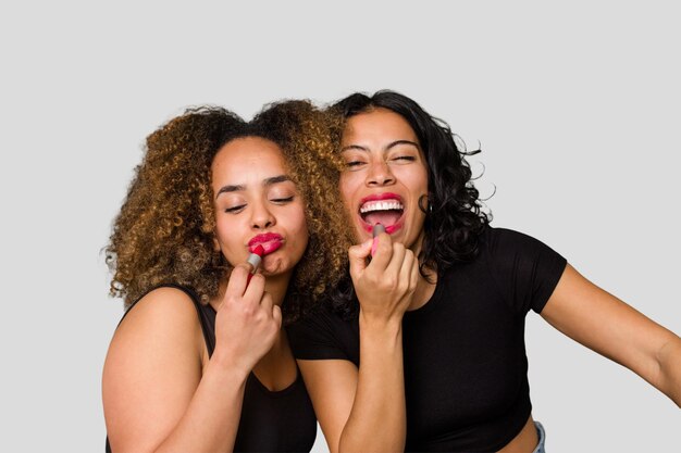 Two best friends an Afro and Latina get ready for a night out laughing and having a great time