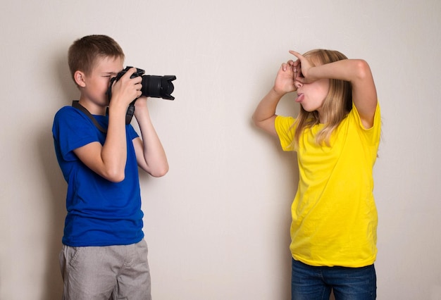 Two best friends teens making photo on their camera at home having fun together joy and happiness