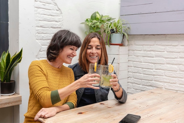 Two best friends toasting with favorite drink