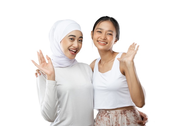 Two bestfriend smiling with waving to the camera