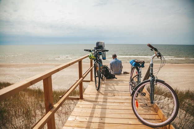 Two bicycles with child seat parked near the beach