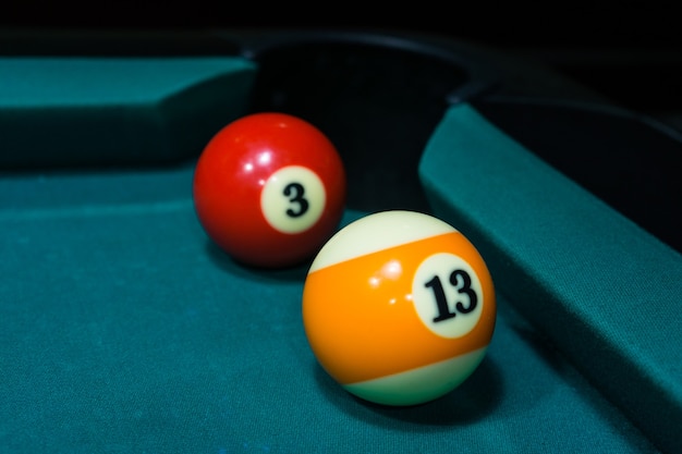 Photo two billiard balls near the pocket