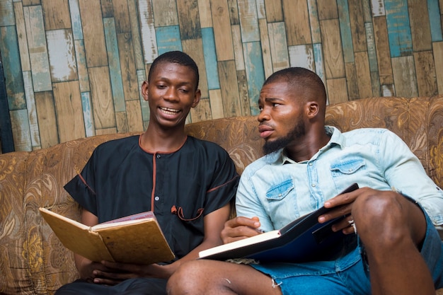 Two black african seriously student studying their school work against their exam.