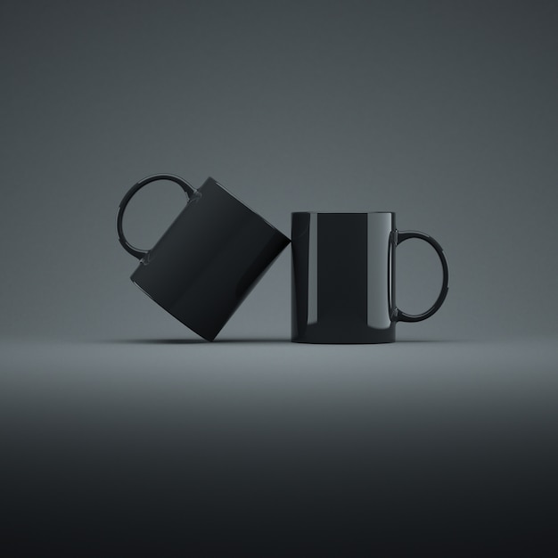 Two black ceramic cups. Dark background.