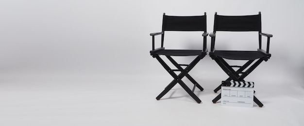 Two black director chair and clapper board on white background