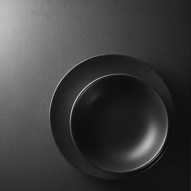 two black plates in the corner on a black background