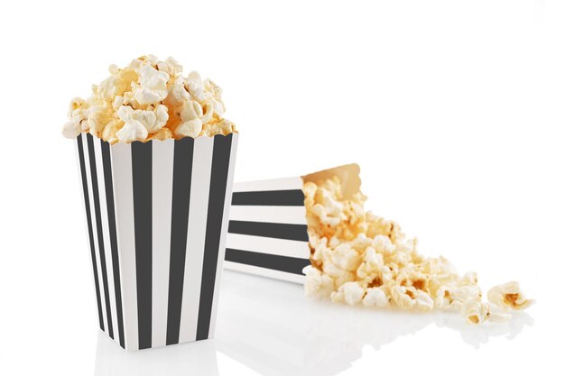 Two black white striped carton buckets with tasty cheese popcorn isolated on white background