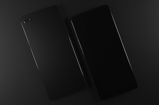 Photo two blank front and back phones with camera on black background model design concept copy space 3d rendering