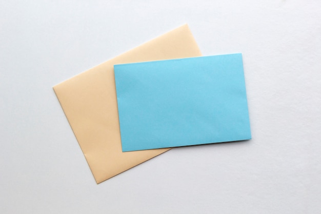 Two blank paper envelopes for mail on white, flat lay, top view. 