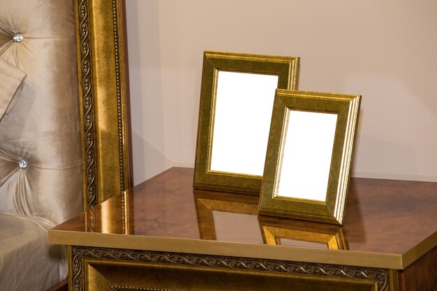 Two blank photo frame on the chest of drawers. Mock up of blank photo frames