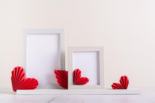 Two blank photo frames decorated with DIY paper hearts Home decor