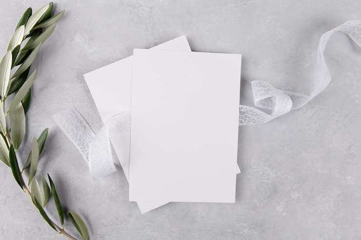 Photo two blank wedding invitation stationery card mockup on grey stone table background with olive branches, 5x7