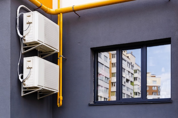 Two block (box) air conditioner on the front of the building.