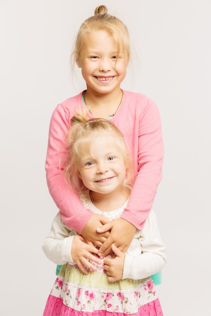 Two blonde little girls smiling