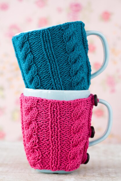 Two blue cups in blue and pink sweater