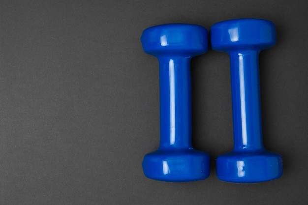 Two blue of dumbbells Isolated on black background