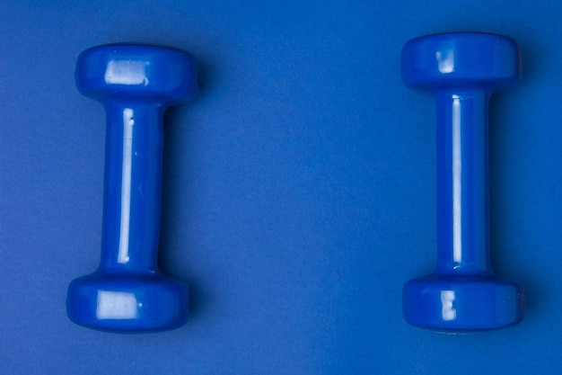 Two blue of dumbbells Isolated on blue background