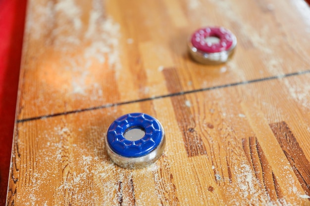 Two blue and red dice on a table with the word game on it.