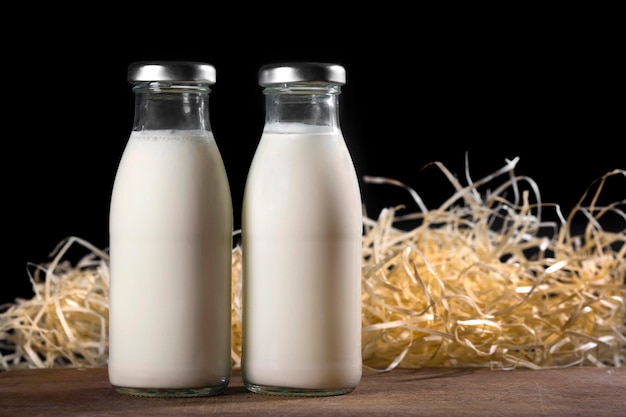 Two bottles of fresh milk on a black background healthy food