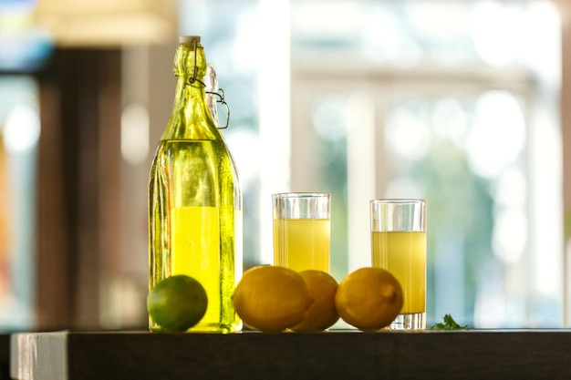 Two bottles and glasses filled with fresh citrus lemonade
