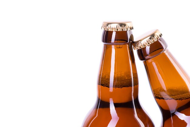 Two bottles of ice cold beer isolated on white