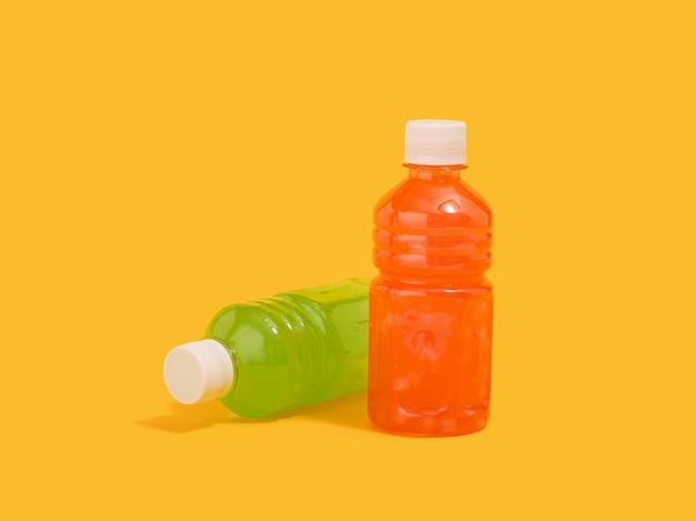Two bottles with colorful juices and fruit pieces Useful drinks and health