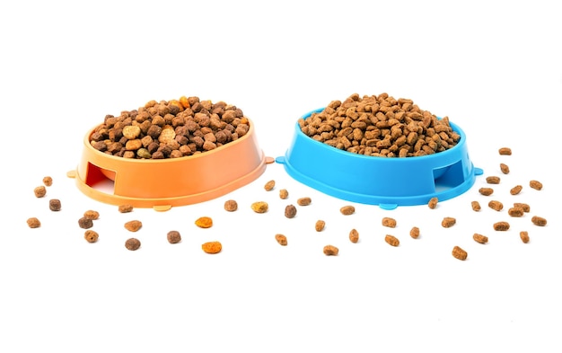 Two bowls with dry food for cats and dogs on a white background.