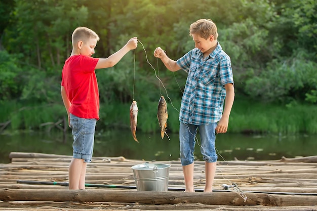 Premium Photo  Two boys of a friend on a fishing trip are