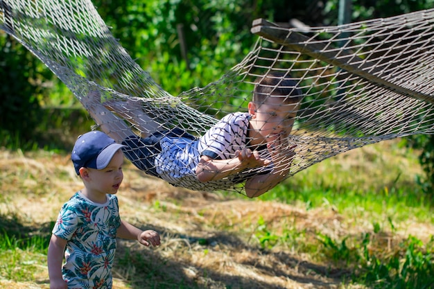 Two boys in a hammock in the garden.