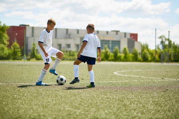 Two Boys Playing on Football Field