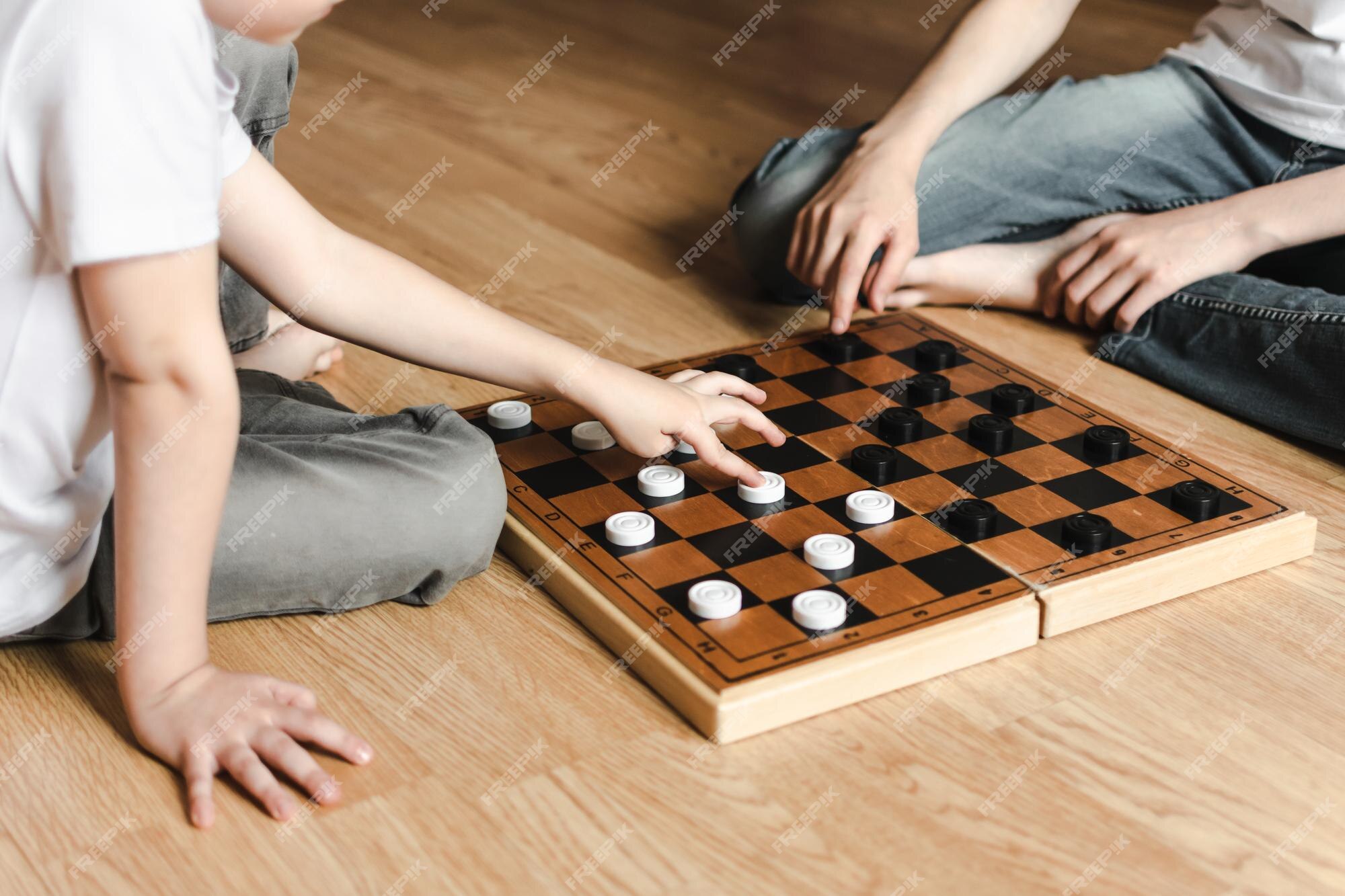 Premium Photo  Two young man are playing chess