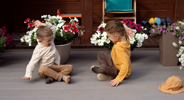 Two boys playing on the veranda of a wooden house