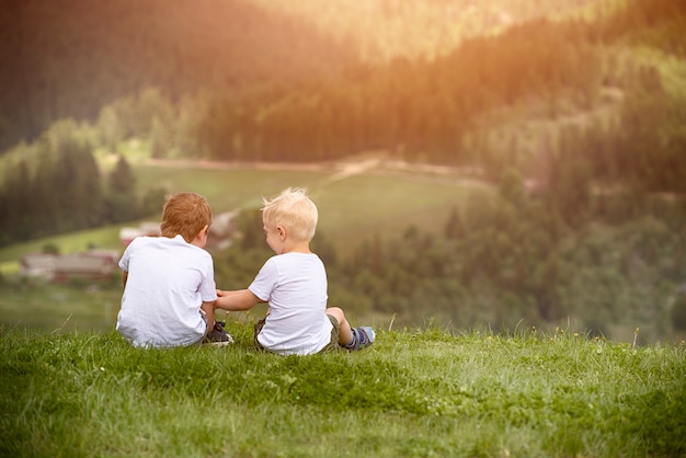 Two boys sit on the hill