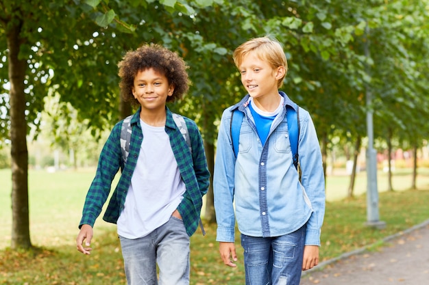 Two boys walking outdoors