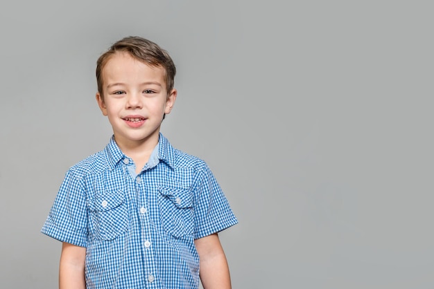 two boys with a clean and painted face on a gray background toned