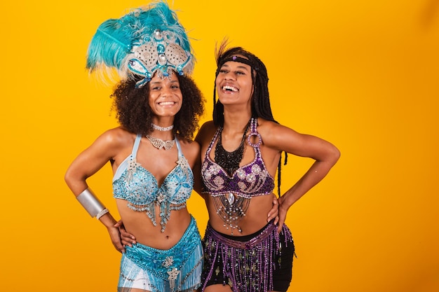 Two brazilian women friends in carnival clothes hands on waist