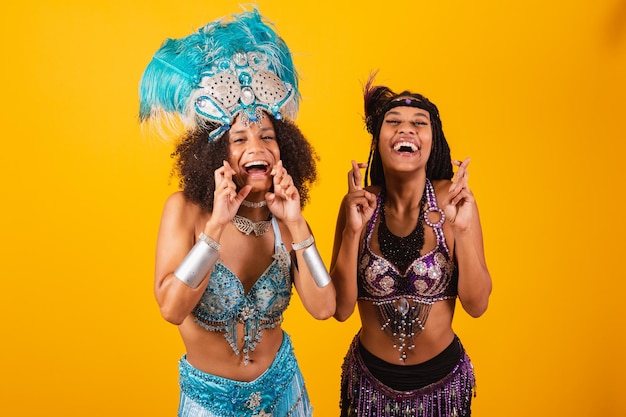 Two Brazilian women friends in carnival clothes shouting promotion