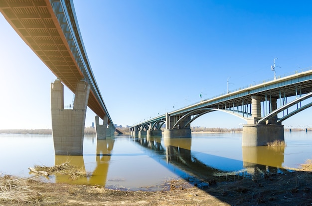 Two bridges across the river, one metro bridge railway, and automobile.