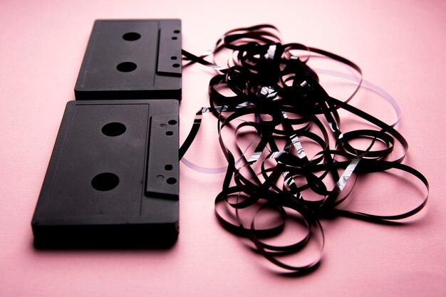 Photo two broken cassettes with the tape out