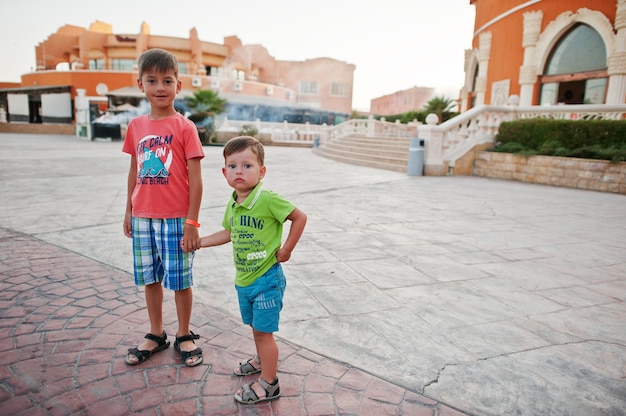 Two brothers holding hands on egyptian resort.