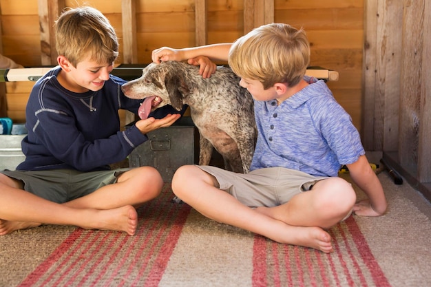 Two brothers playing with their dog