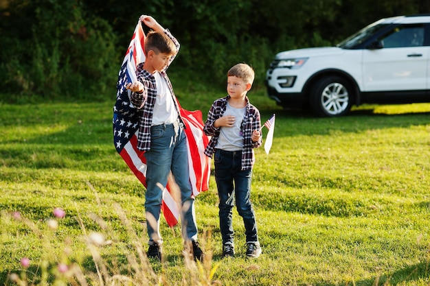 Two brothers with USA flag America holiday Proud to be children of country