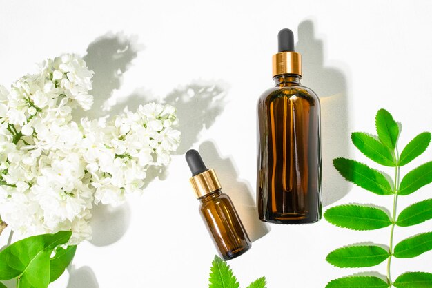 Two brown glass bottles with a natural cosmetic product Essential oils and body serum