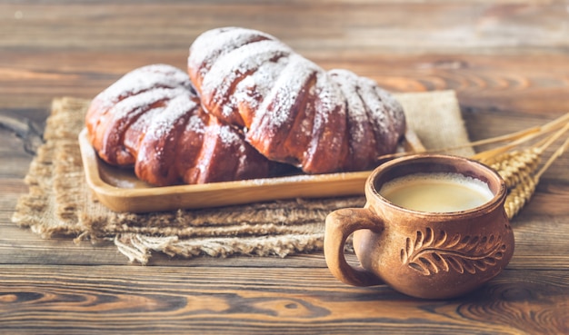 Two buns with cup of coffee