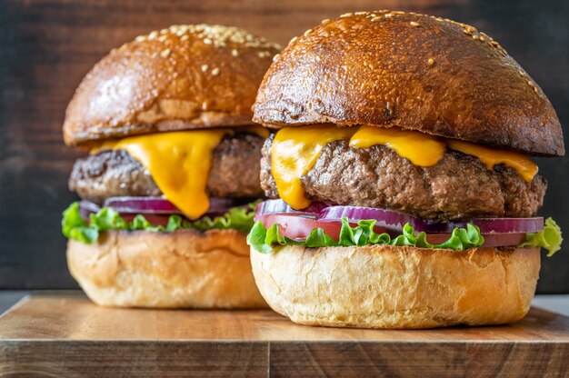 Two burgers on the wooden board close up