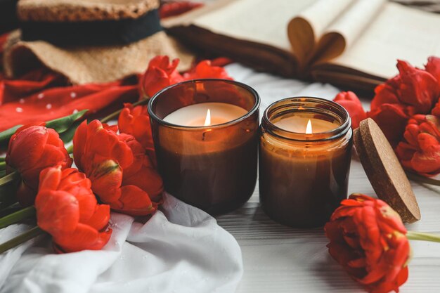 Two burning candles in home interior book with heart aesthetic photo