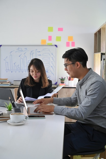 Two business colleagues meeting for new project planning in modern office.