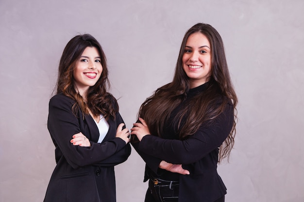 Two business entrepreneur friends in grey background