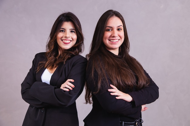 Two business entrepreneur friends in grey background