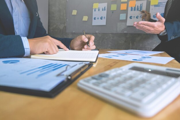 two business executives analyzing data paper at meeting room